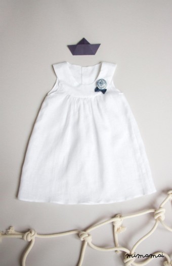 White linen baby dress with Bella brooch
