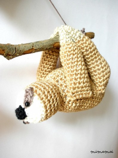 Stuffed sloths couple on a branch with red heart