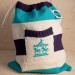 Knitted drawstring bag with carousel motif pocket in Turquoise