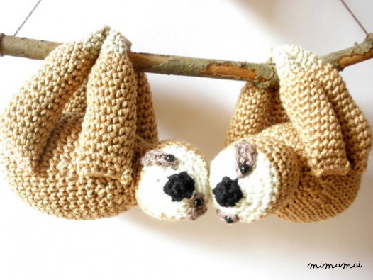 Stuffed sloths couple on a branch with red heart