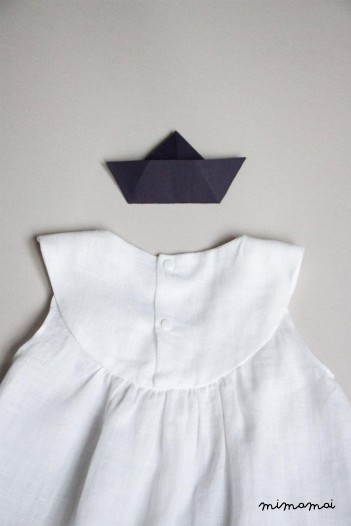 White linen baby dress with Bella brooch